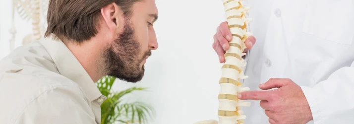 Chiropractic Council Bluffs IA Man Looking at Spine Model